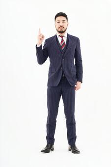 人差し指を立てるポーズをする男性 ナンバーワン,一番,ポーズの写真素材