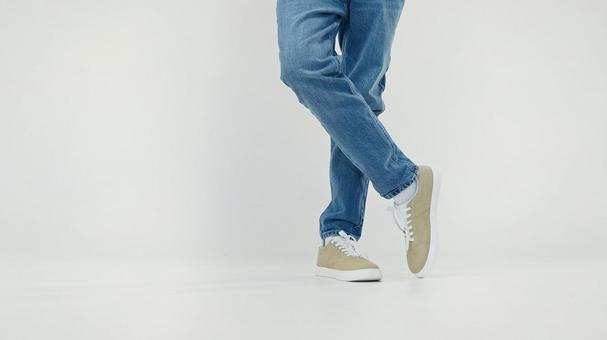 足をクロスして立つ人の足元 足をクロスして立つ人の足元の写真