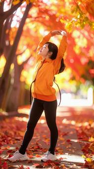 スポーツの秋 紅葉の中でストレッチ 女性 スポーツの秋 紅葉の中でストレッチ 女性の写真