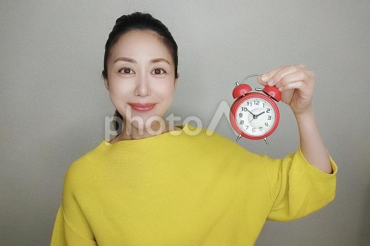 目覚まし時計を持つ女性 女性,人物,ビジネスの写真素材