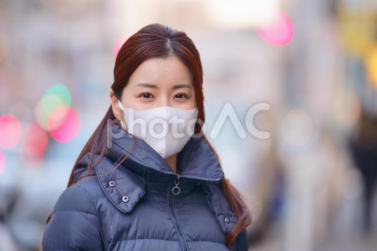 街にいるマスクをしたダウンコートの女性 女性,日本人,1人の写真素材