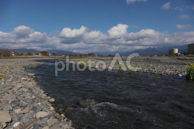 広い河原と遠くに見える山と雲 浜,水,風景の写真素材