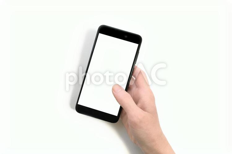 白背景スマートフォンを持つ手の合成用素材 スマートフォン,スマホ,スマートホンの写真素材
