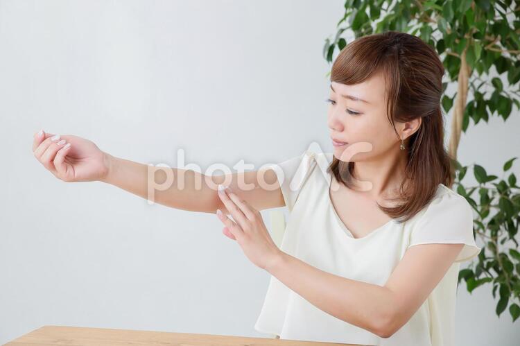 クリームを塗る女性 腕,肌荒れ,塗るの写真素材