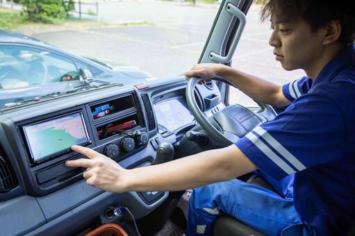 トラック運転手がナビを操作する カーナビ,ナビ,ナビ操作の写真素材