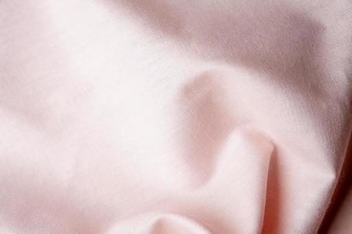 ピンク布のしわテクスチャ背景の写真