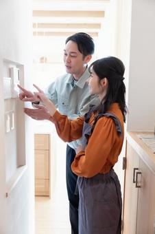 Contractor checking the intercom, JPG Contractor checking the intercom, JPG