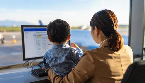 A mother working remotely and looking at a computer with her child, computer, screen, child, JPG