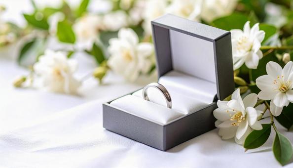 ケースに入った結婚指輪 背景に花 ケースに入った結婚指輪 背景に花の写真