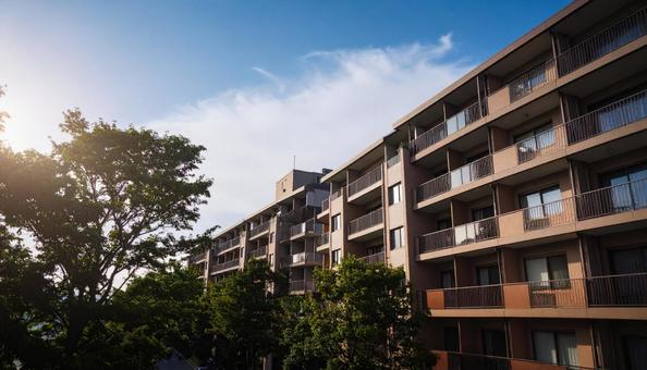 高層マンションを見上げる　青空背景の写真