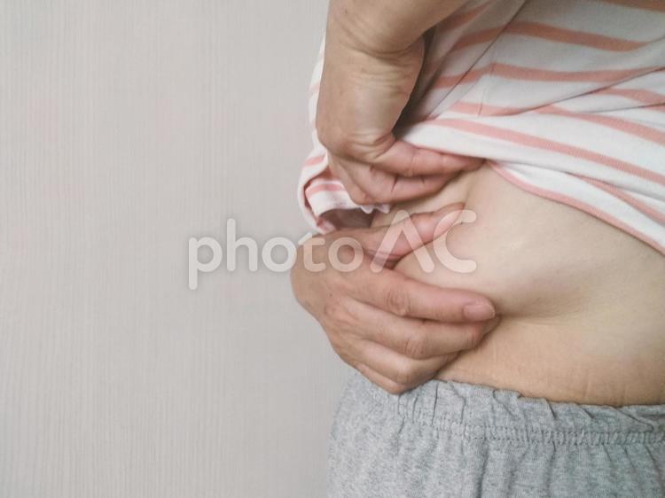 体脂肪を絞りたい 太る,二段腹,贅肉の写真素材