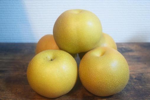 木のテーブルに盛られた日本の梨 木のテーブルに盛られた日本の梨の写真
