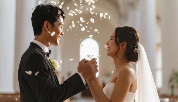 紙吹雪が舞い落ちる教会の新郎新婦の写真