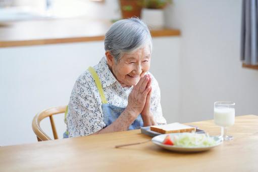笑顔でいただきますのポーズをする高齢女性 女性,いただきます,ポーズの写真素材
