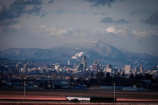 仙台市と雪山の遠景 仙台市,宮城県,日本の写真素材