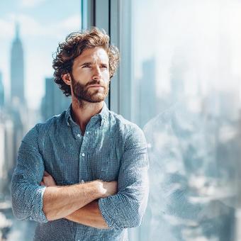 Determined man standing with a cityscape in the background, male, executive, businessman, JPG