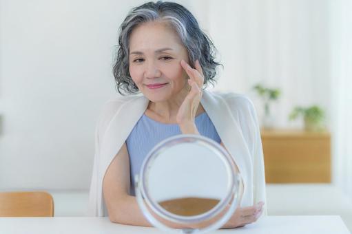 スキンケアをするシニア女性 スキンケアをするシニア女性 美容,シニア,笑顔の写真素材