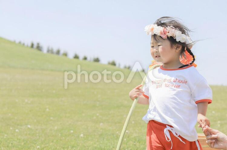 風が強いとなげく女の子 女の子,子供,原っぱの写真素材