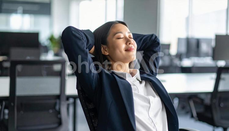 オフィスで目を閉じリラックスする女性社員 女性社員,オフィス,リラックスの写真素材