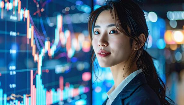 ディルプレイのチャートの前に立つ女性社員の写真