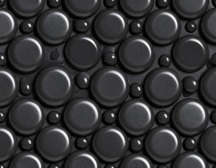 黒いワックスの石と水滴模様 黒いワックスの石と水滴模様の写真