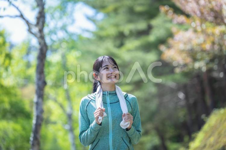 緑の中でウォーキングする女性（森林浴・タオル） ウォーキング,森林浴,有酸素運動の写真素材