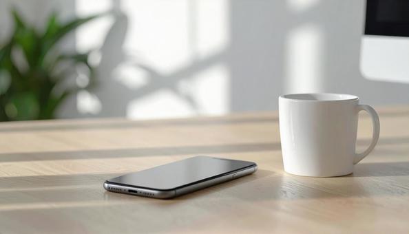 テーブルのコーヒーとスマホの写真