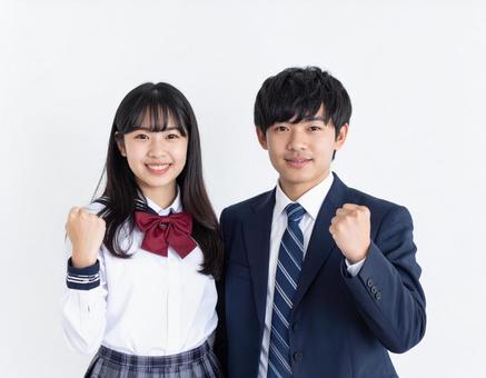 ガッツポーズする高校生男女 ガッツポーズする高校生男女の写真