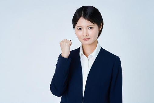応援のポーズをするスーツ姿の若い女性 女性,若い女性,ビジネスウーマンの写真素材