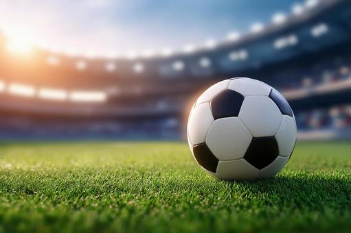 光に包まれたサッカーフィールドのボール 光に包まれたサッカーフィールドのボールの写真