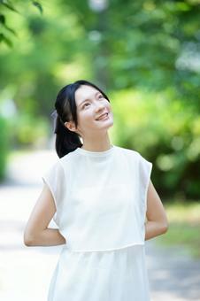 女性が後ろ手に立つの写真