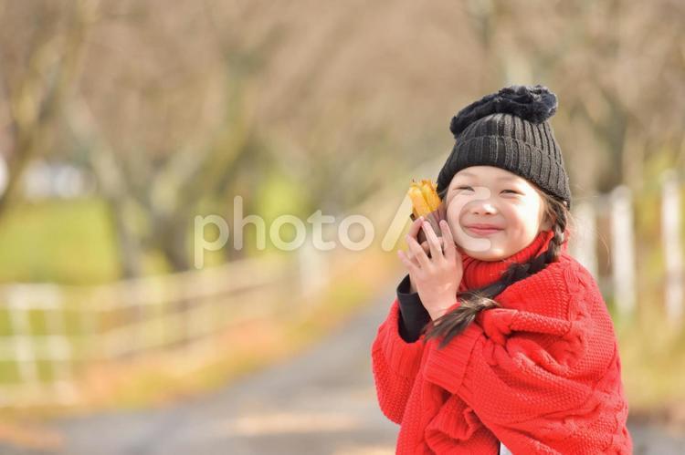 焼き芋を持つ子供 11月,mdfk023,あたたかいの写真素材