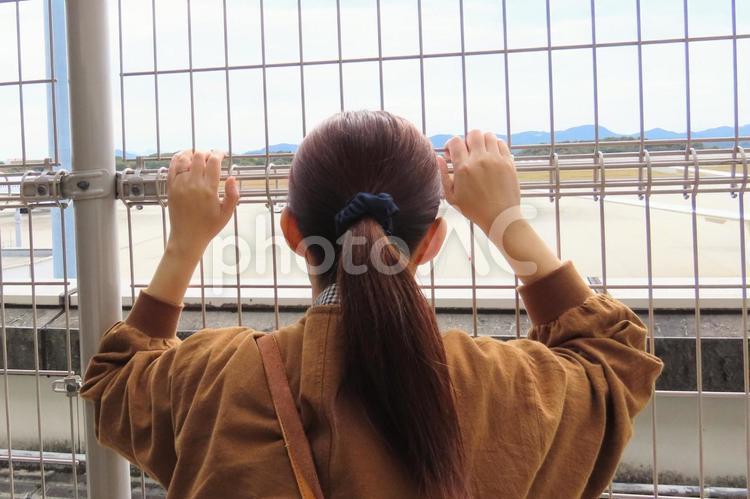 広島空港で飛行機を見送る女性の後ろ姿 空港,飛行場,女性の写真素材