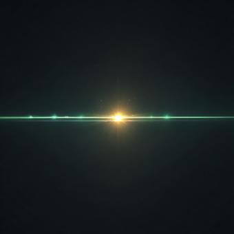 暗闇に輝くグリーンのレンズフレア	の写真