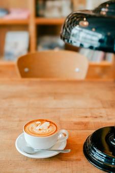 Latte art in a cafe with a bookshelf in the background, JPG Latte art in a cafe with a bookshelf in the background, JPG