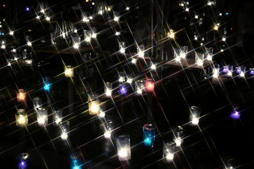 クロスフィルターで輝く多数のキャンドル キャンドル,キャンドルナイト,ろうそくの写真素材