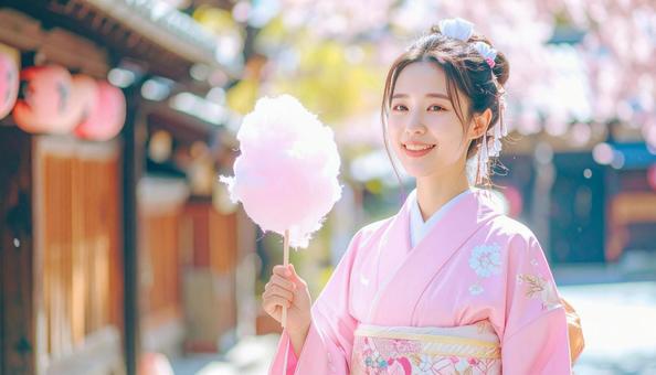 綿菓子を持つ女性の写真