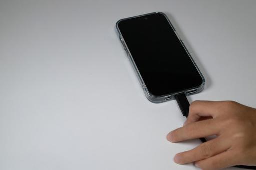 充電中のスマホと接続されたケーブル スマートフォン,充電,ケーブルの写真素材