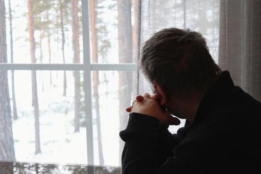 Pensive man looking out the window, JPG