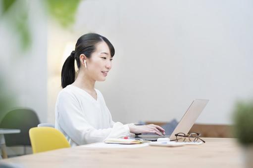 A woman working in a casual space, female, telework, pc, JPG