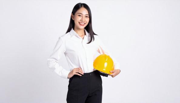 ヘルメットを抱え笑顔の若い日本人女性 ヘルメットを抱え笑顔の若い日本人女性の写真