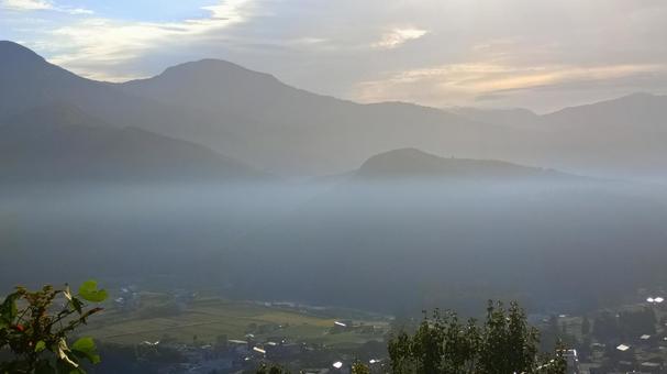 朝の山から下の街を見下ろした風景 朝の山から下の街を見下ろした風景 山,雲,街の写真素材