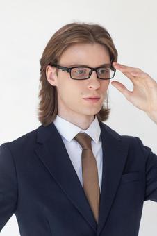 メガネに手をやるスーツの男性 男性,外国人,欧米人の写真素材