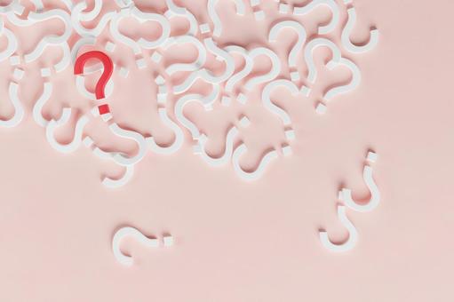 A large number of white question marks and one red question mark lying on the floor A large number of white question marks and one red question mark lying on the floor