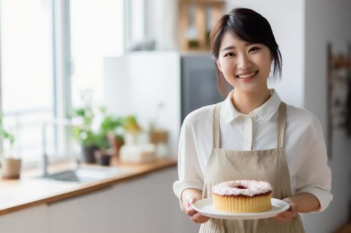 ケーキを手に持つ料理家01 ケーキを手に持つ料理家01の写真