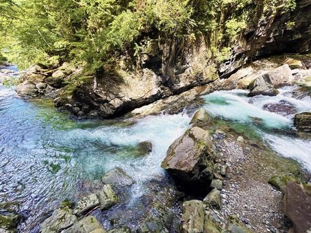 Scenery of a mountain stream flowing through rocks, JPG