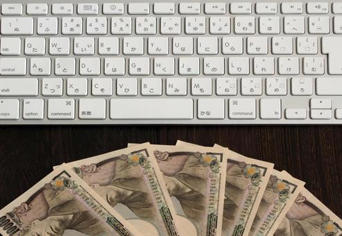 鍵盤と千円札のイメージ 鍵盤と千円札のイメージ キーボード,パソコン,デスクトップの写真素材