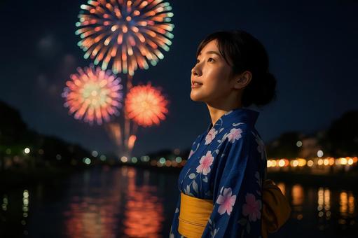 浴衣姿で花火を見る女性 浴衣姿で花火を見る女性の写真