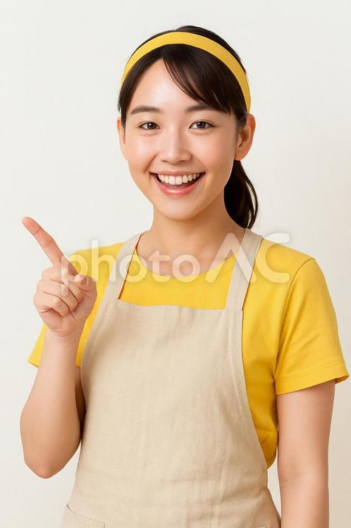 女性が笑顔で指を刺し紹介している風 女性,若い女性,笑顔の写真素材