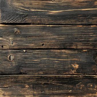 焦げ茶色の古材板の木目背景素材の写真